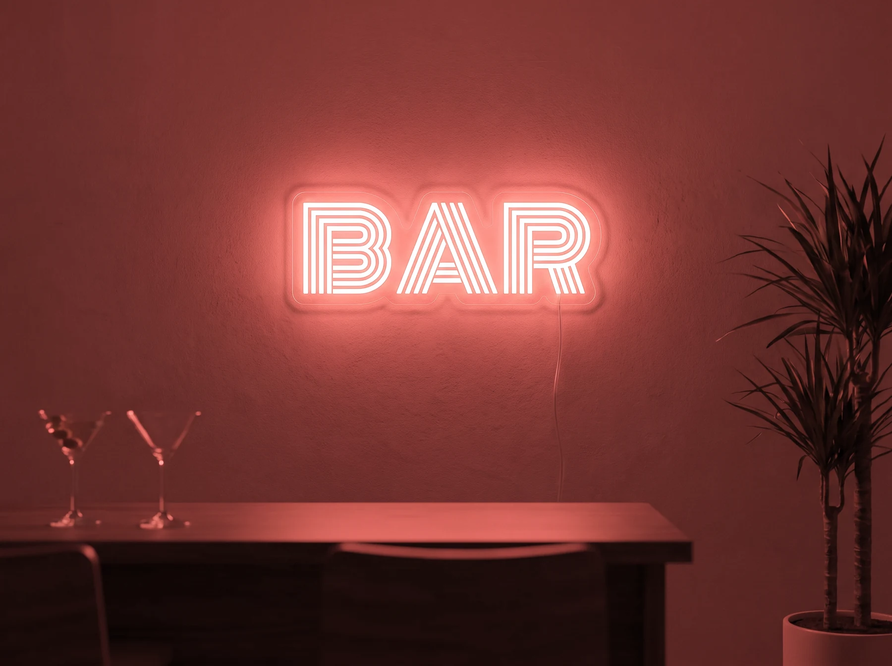 Neonskylt «BAR» i röd LED-neon, monterad på vägg
