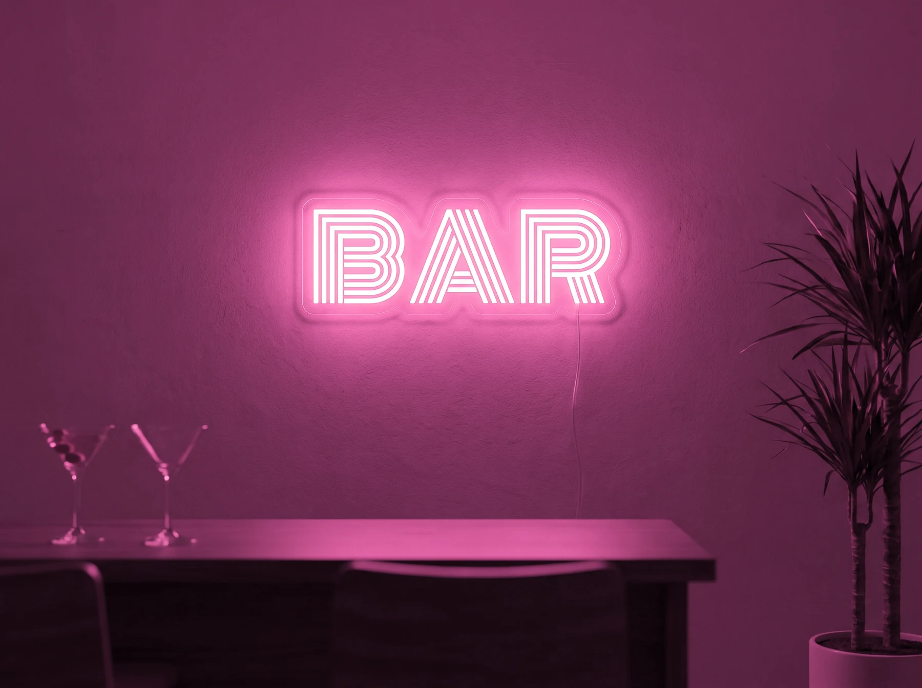 Neonskylt «BAR» i rosa LED-neon, monterad på vägg