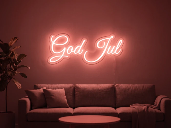 Neonskylt «God Jul» i röd LED-neon, monterad på vägg