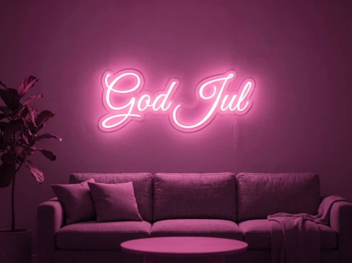 Neonskylt «God Jul» i rosa LED-neon, monterad på vägg