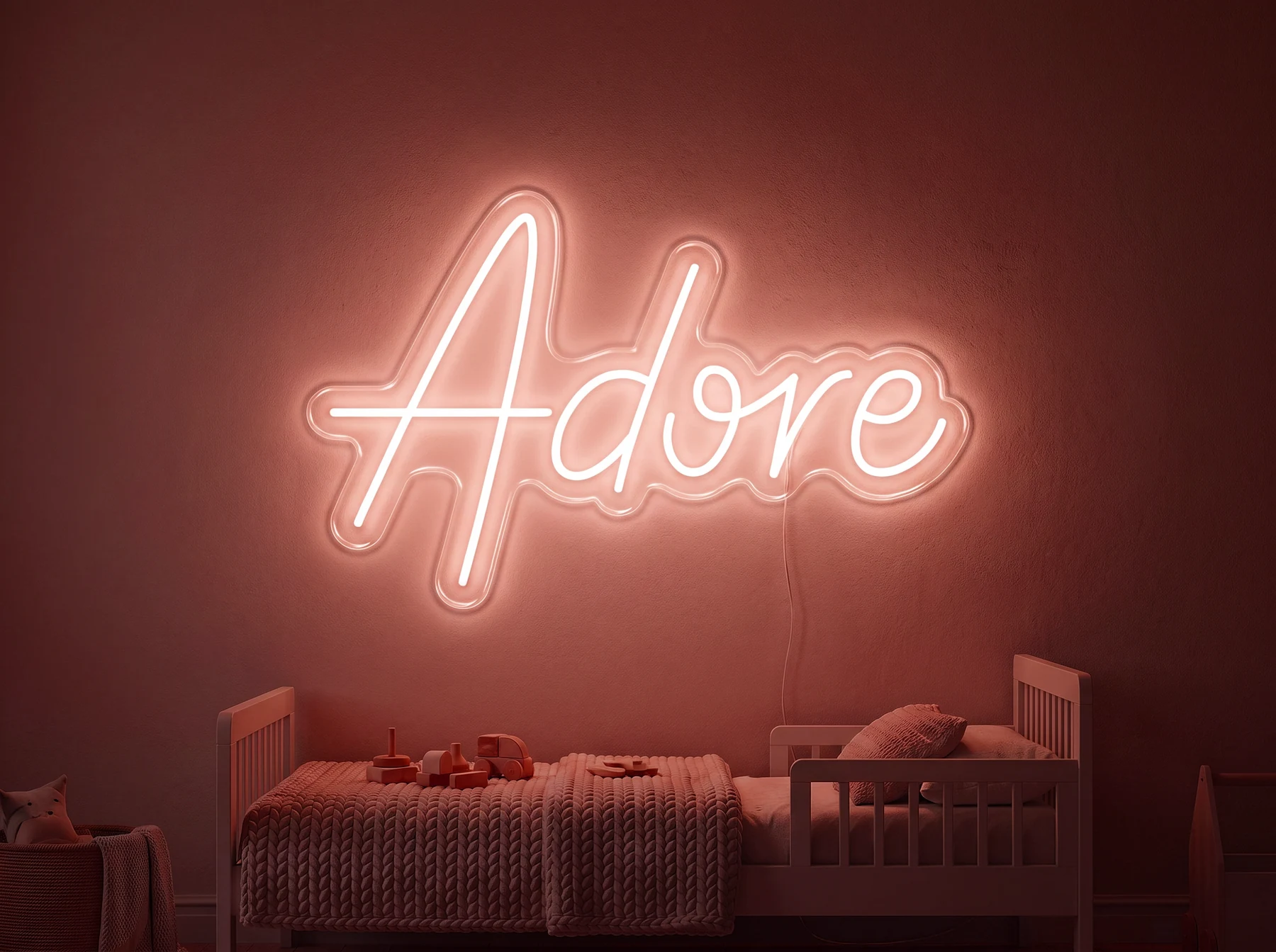 Neonskylt «Adore» i röd LED-neon, monterad på vägg