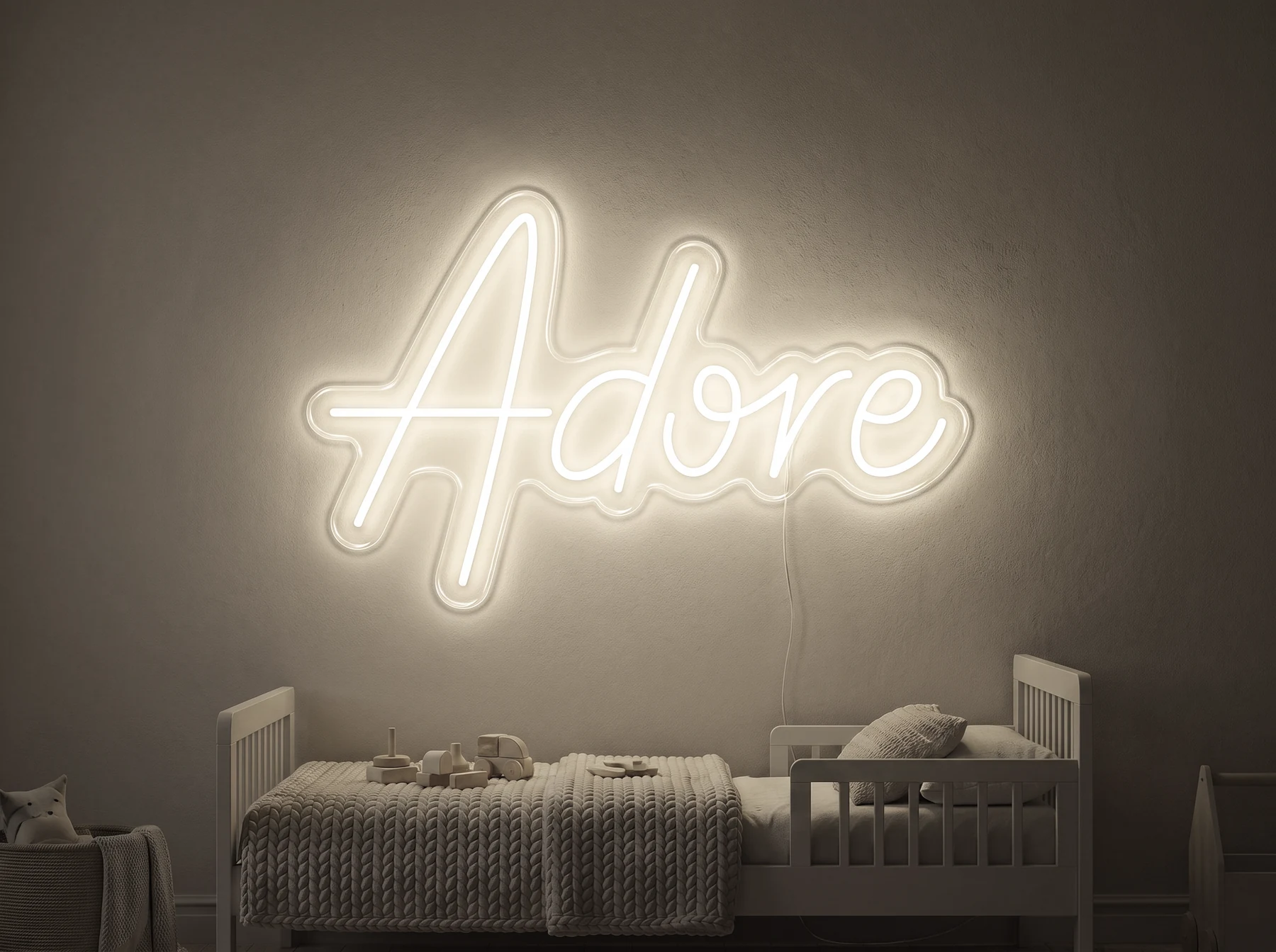 Neonskylt «Adore» i varmvit LED-neon, monterad på vägg