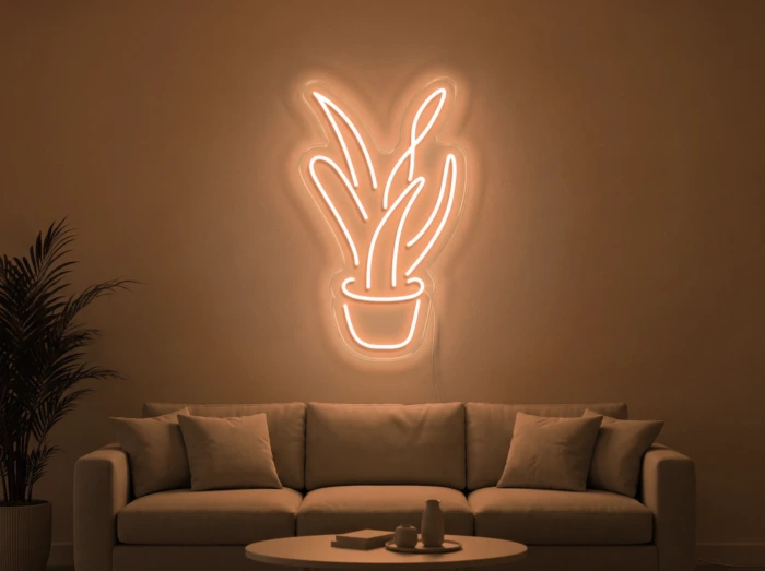 Neonskylt «Aloe vera» i orange LED-neon, monterad på vägg