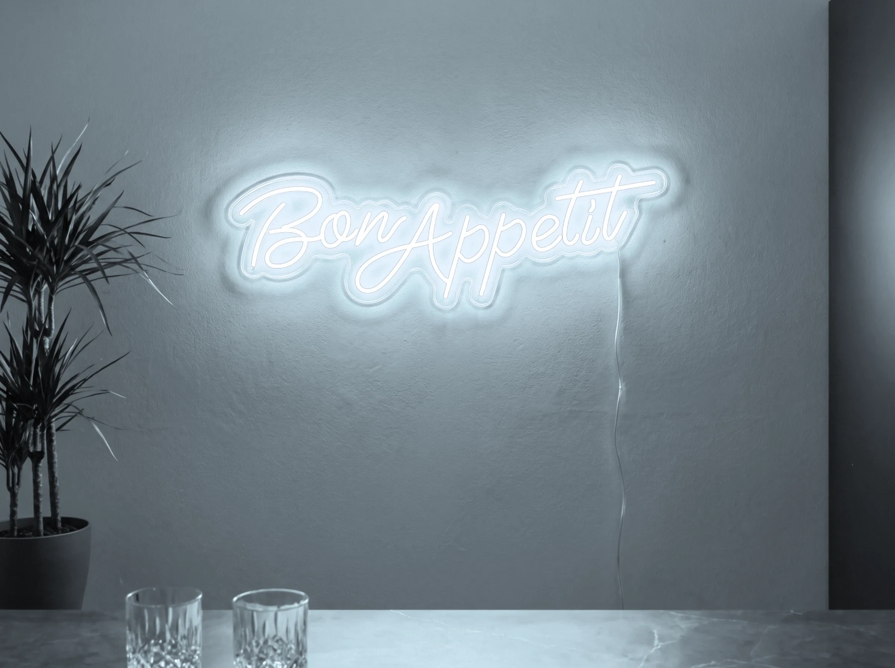 Neonskylt «Bon Appétit» i iskall vit LED-neon, monterad på vägg