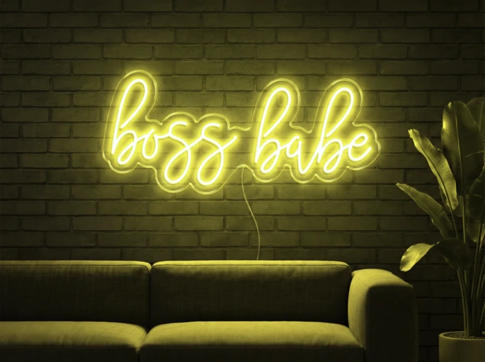 Neonskylt «Boss Babe» i gul LED-neon, monterad på vägg