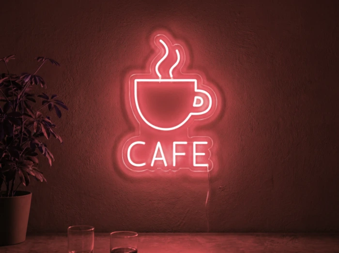 Neonskylt «Cafe» i röd LED-neon, monterad på vägg