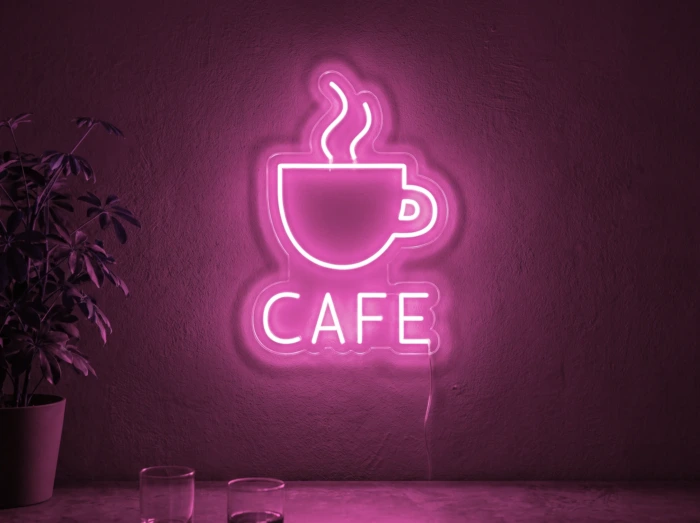 Neonskylt «Cafe» i rosa LED-neon, monterad på vägg