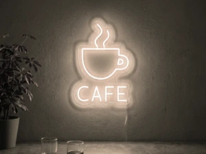 Neonskylt «Cafe» i varmvit LED-neon, monterad på vägg