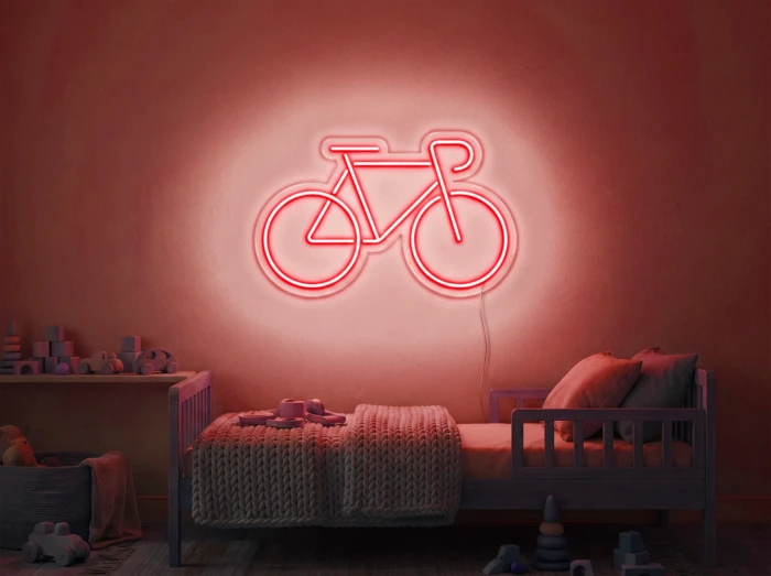 Neonskylt «Cykel» i röd LED-neon, monterad på vägg