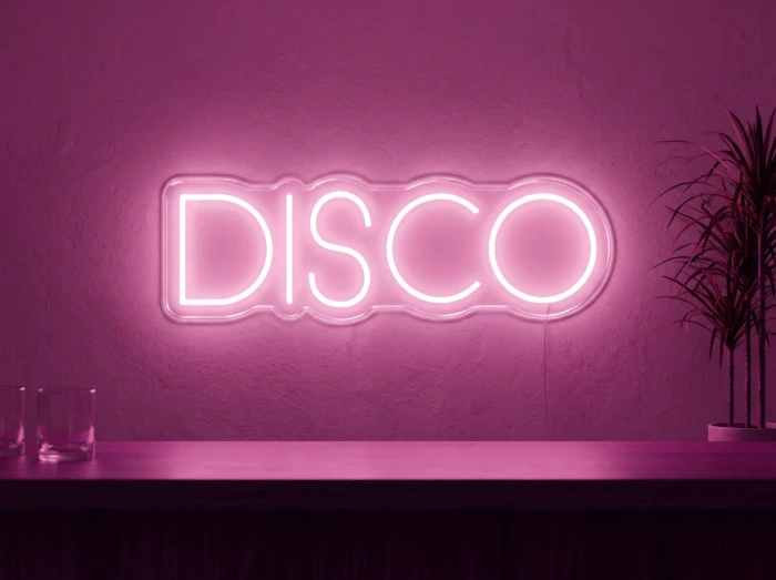Neonskylt «Disco» i rosa LED-neon, monterad på vägg