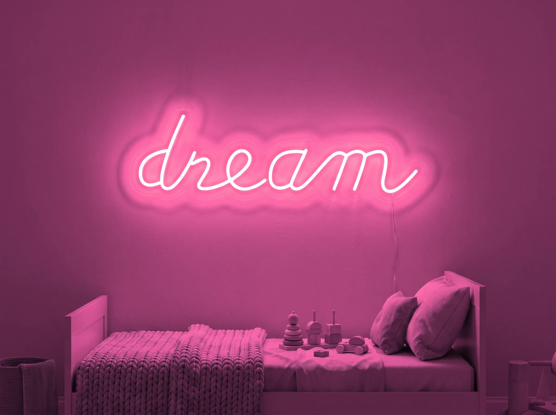 Neonskylt «Dream» i rosa LED-neon, monterad på vägg