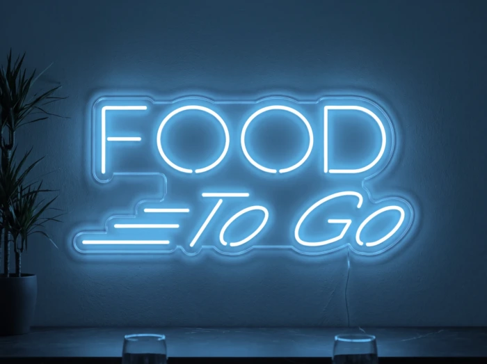 Neonskylt «Food To Go» i isblå LED-neon, monterad på vägg