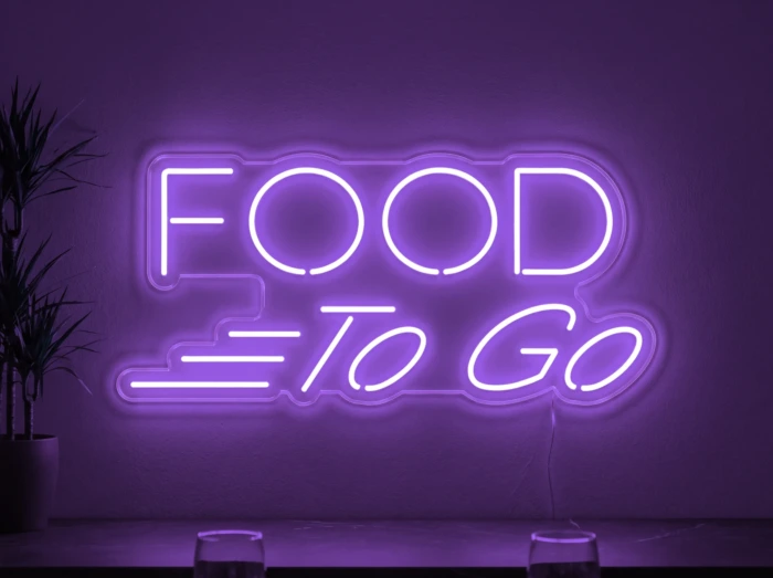 Neonskylt «Food To Go» i lila LED-neon, monterad på vägg