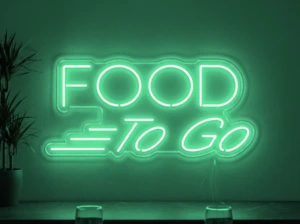 Neonskylt «Food To Go» i mintgrön LED-neon, monterad på vägg