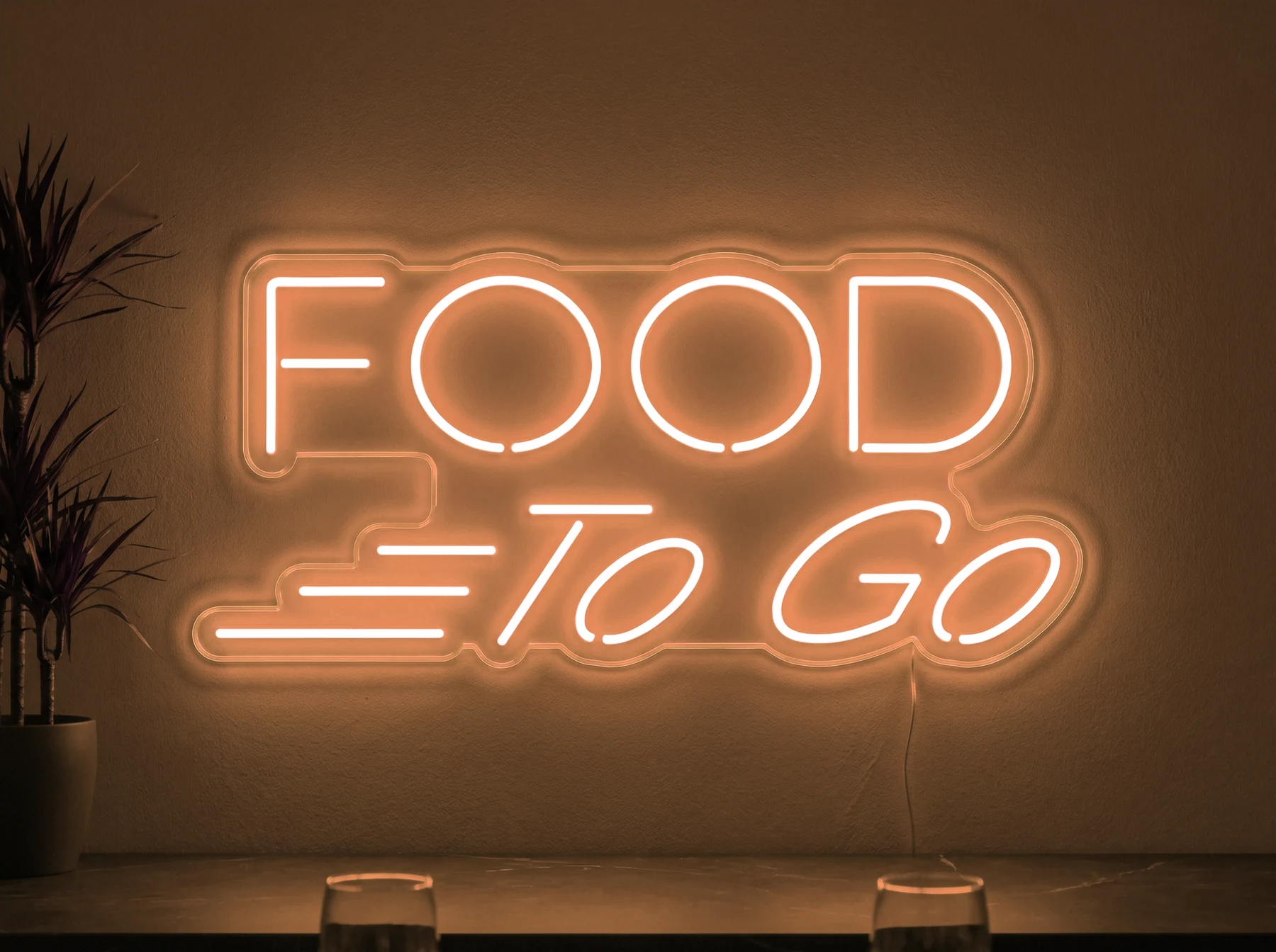 Neonskylt «Food To Go» i orange LED-neon, monterad på vägg