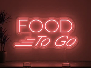 Neonskylt «Food To Go» i röd LED-neon, monterad på vägg