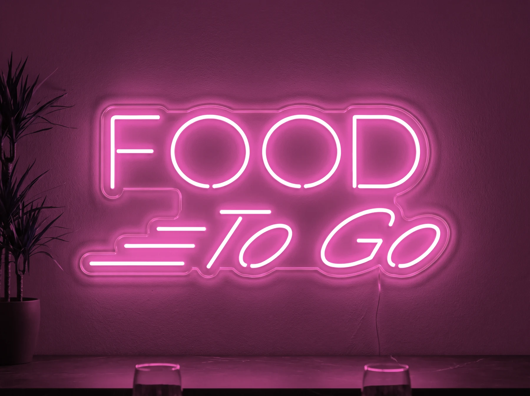 Neonskylt «Food To Go» i rosa LED-neon, monterad på vägg