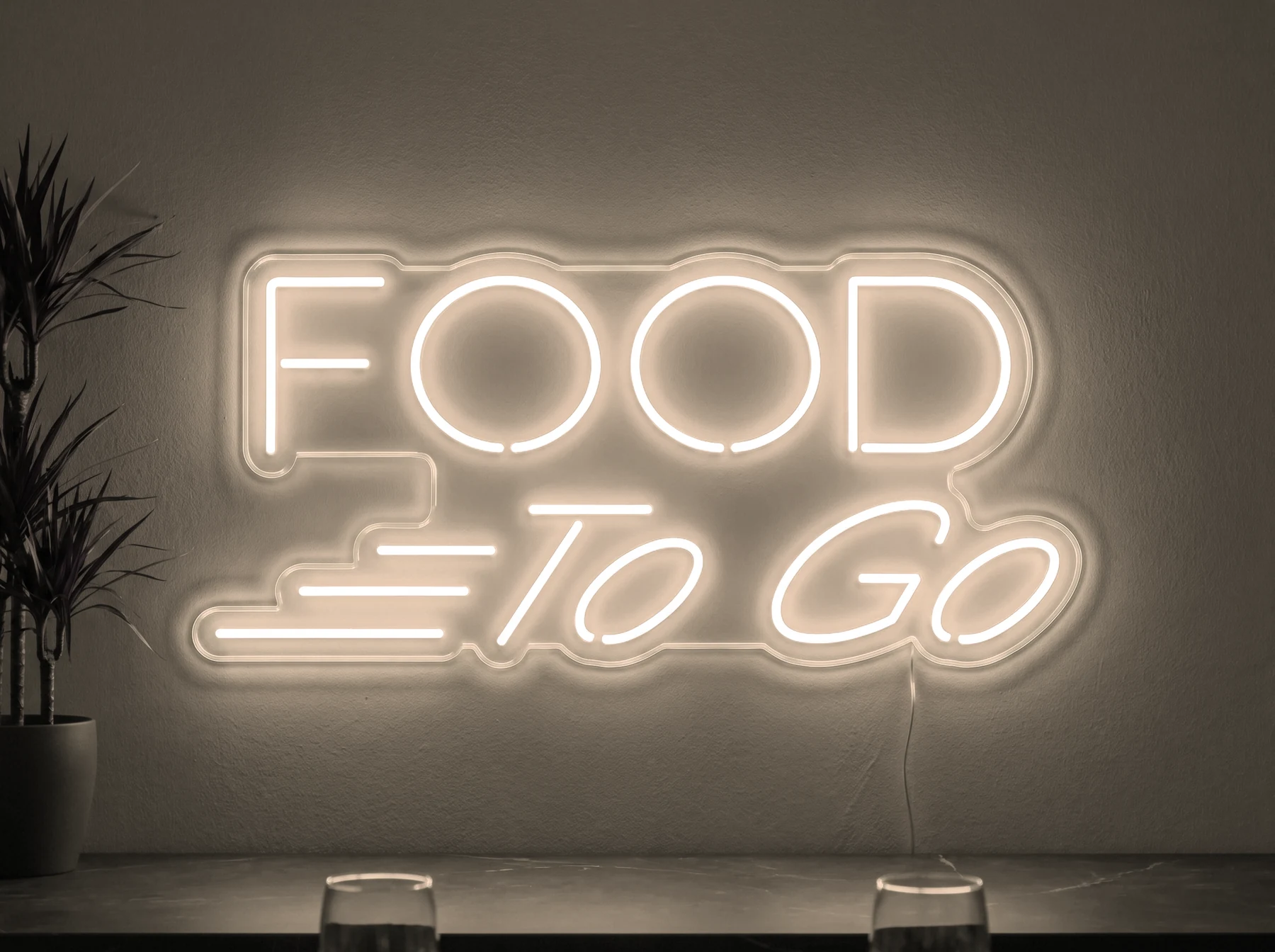 Neonskylt «Food To Go» i varmvit LED-neon, monterad på vägg