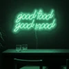 Neonskylt «Good Food Good Mood» i mintgrön LED-neon, monterad på vägg