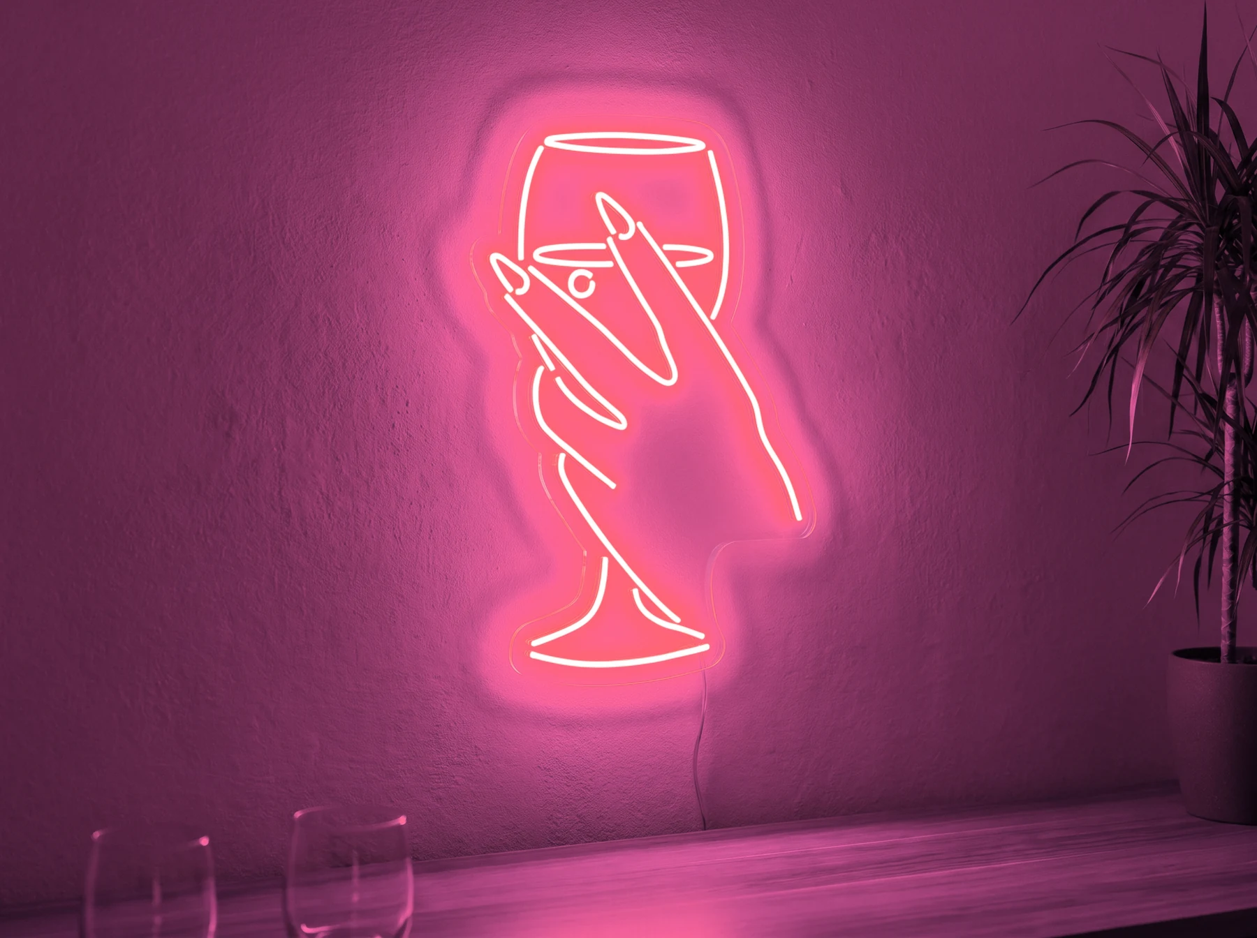 Neonskylt «Hand med glas» i rosa LED-neon, monterad på vägg