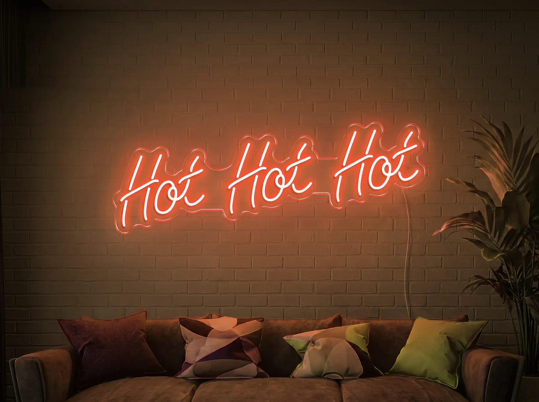 Neonskylt «Hot Hot Hot» i orange LED-neon, monterad på vägg