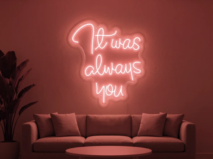 Neonskylt «It Was Always You» i röd LED-neon, monterad på vägg
