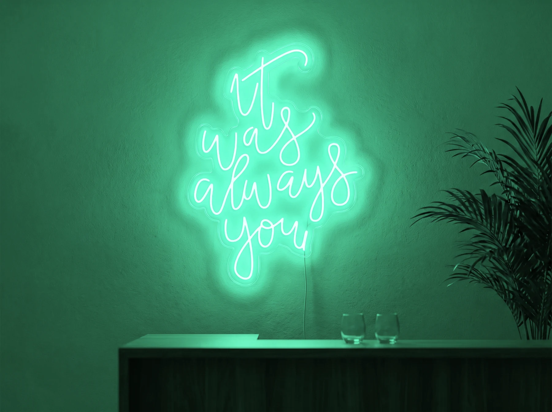 Neonskylt «It Was Always You, smal» i mintgrön LED-neon, monterad på vägg