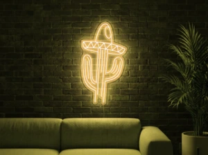 Neonskylt «Kaktus med hatt» i gul LED-neon, monterad på vägg