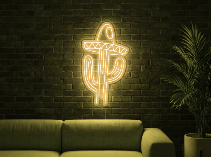 Neonskylt «Kaktus med hatt» i gul LED-neon, monterad på vägg
