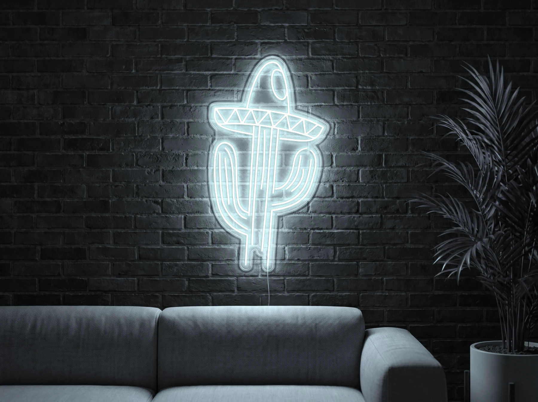 Neonskylt «Kaktus med hatt» i iskall vit LED-neon, monterad på vägg