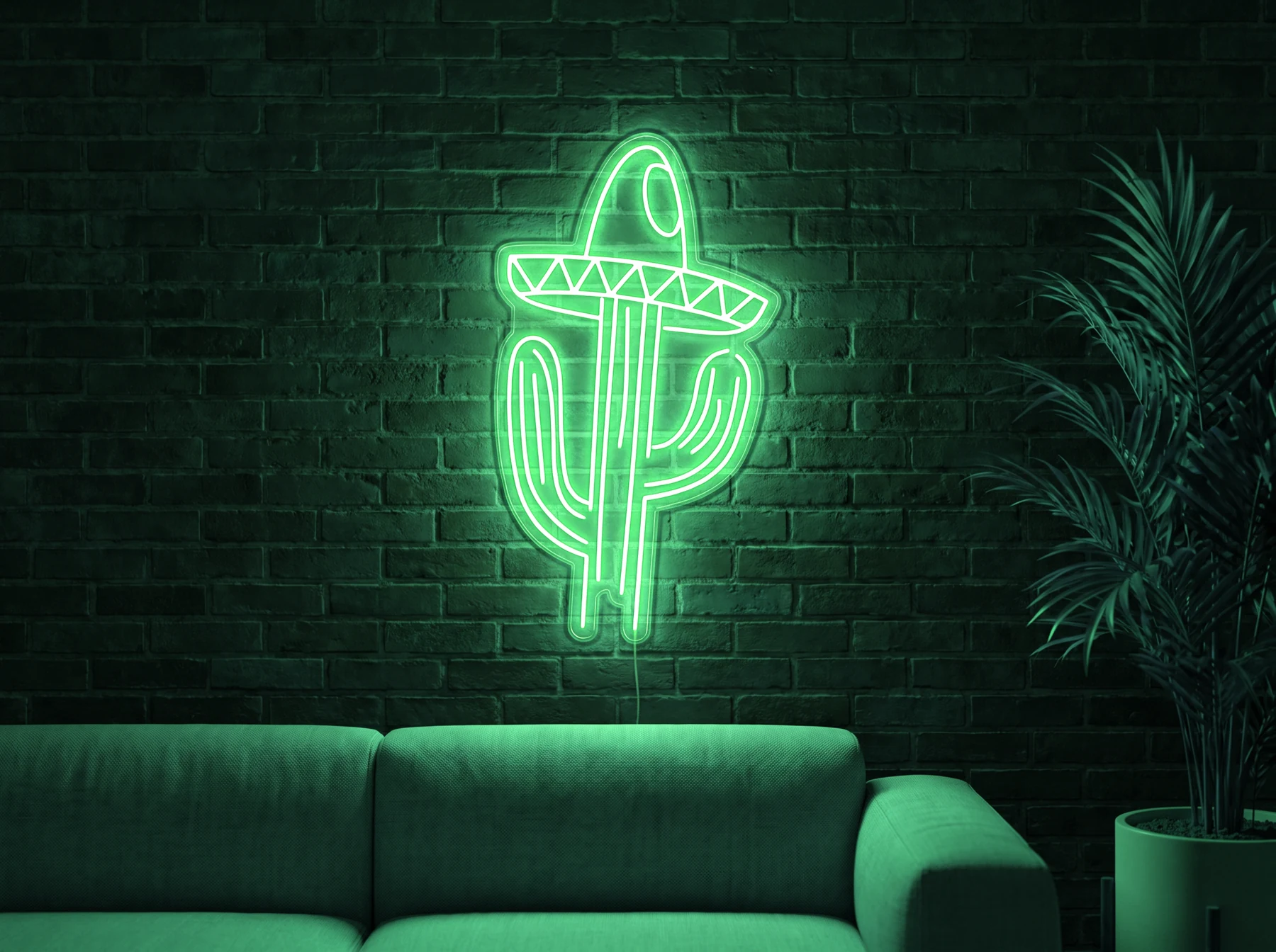 Neonskylt «Kaktus med hatt» i mintgrön LED-neon, monterad på vägg
