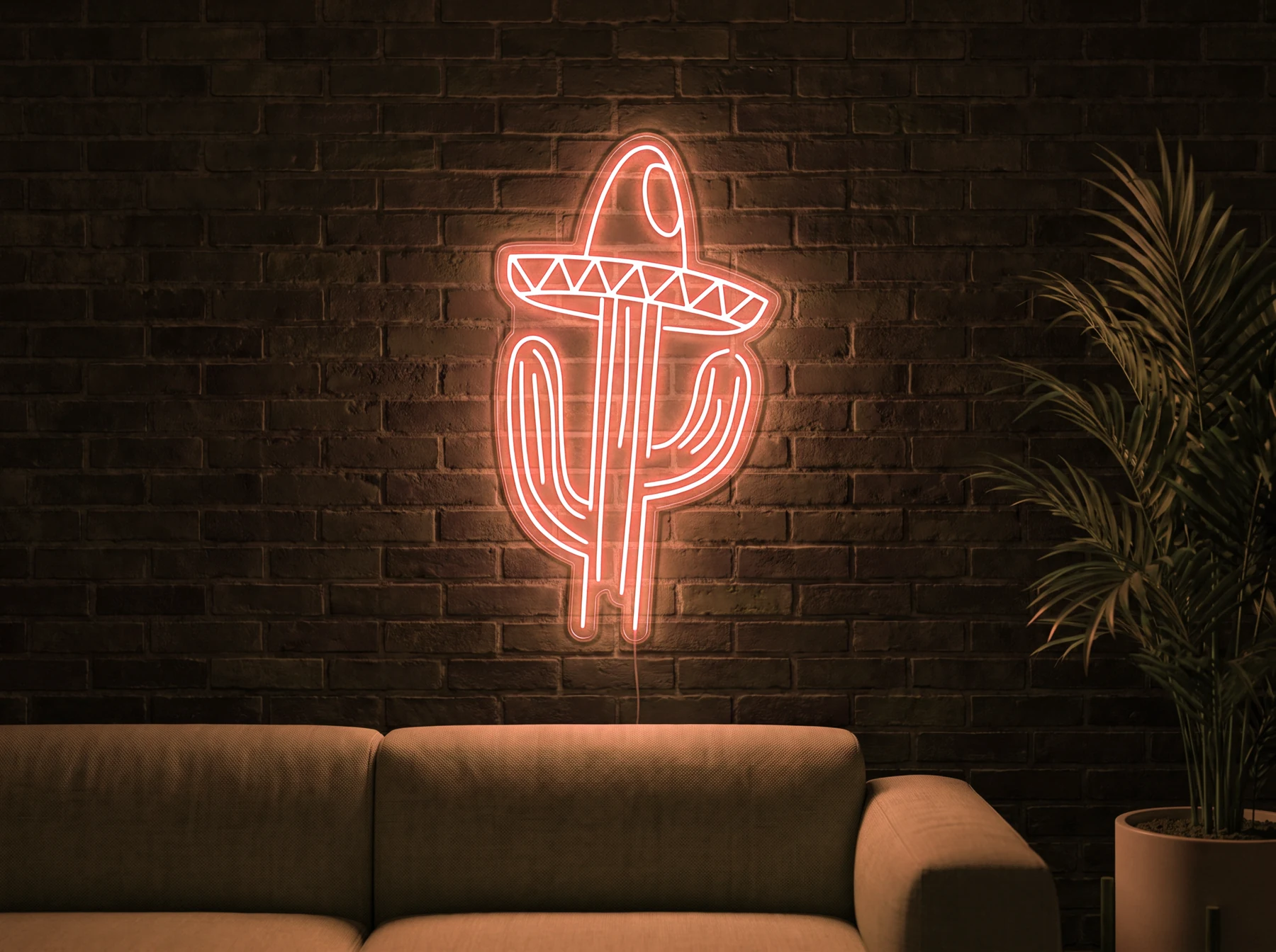 Neonskylt «Kaktus med hatt» i orange LED-neon, monterad på vägg
