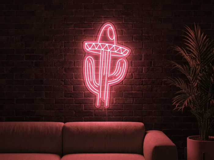Neonskylt «Kaktus med hatt» i röd LED-neon, monterad på vägg