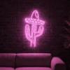 Neonskylt «Kaktus med hatt» i rosa LED-neon, monterad på vägg