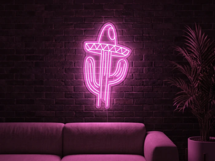 Neonskylt «Kaktus med hatt» i rosa LED-neon, monterad på vägg
