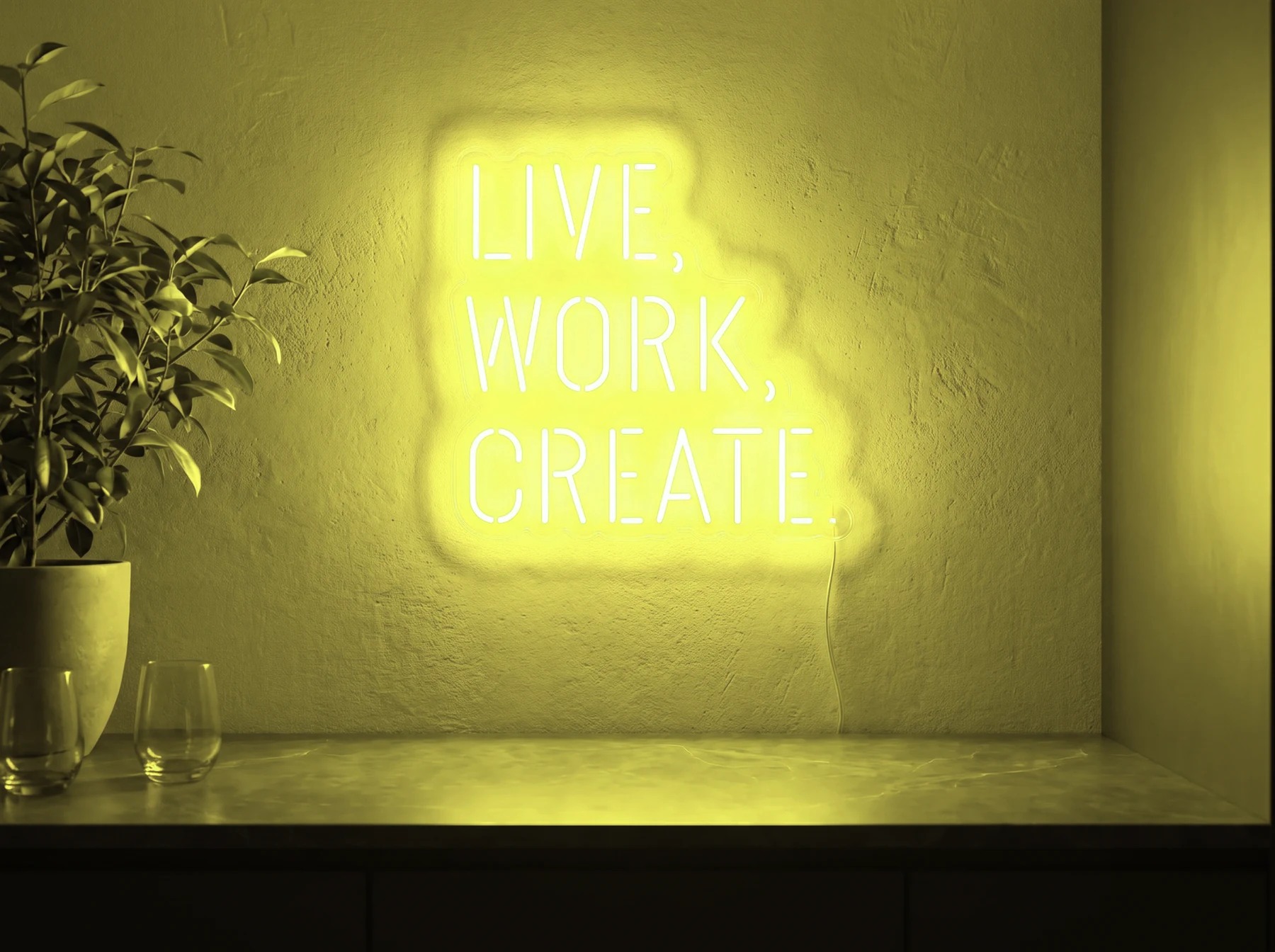 Neonskylt «Live Work Create» i gul LED-neon, monterad på vägg