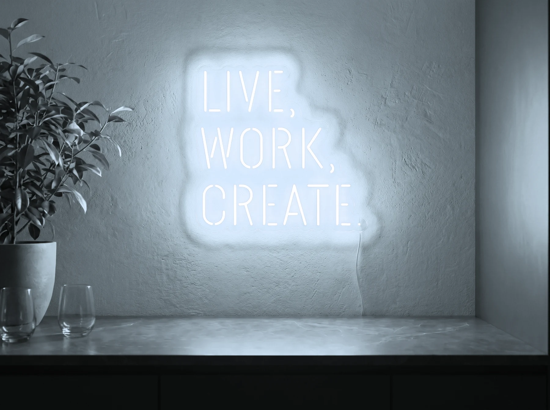 Neonskylt «Live Work Create» i iskall vit LED-neon, monterad på vägg
