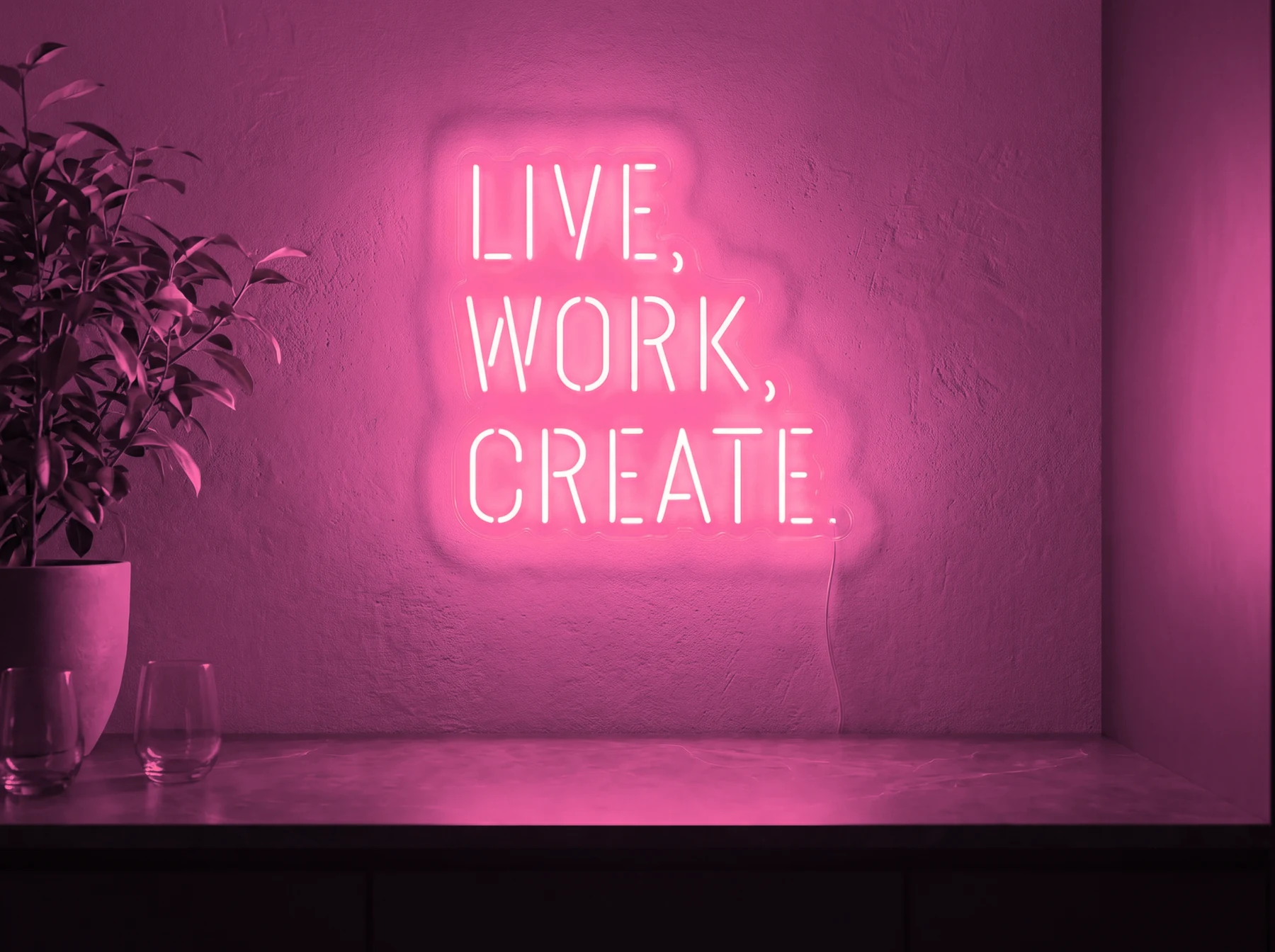 Neonskylt «Live Work Create» i rosa LED-neon, monterad på vägg