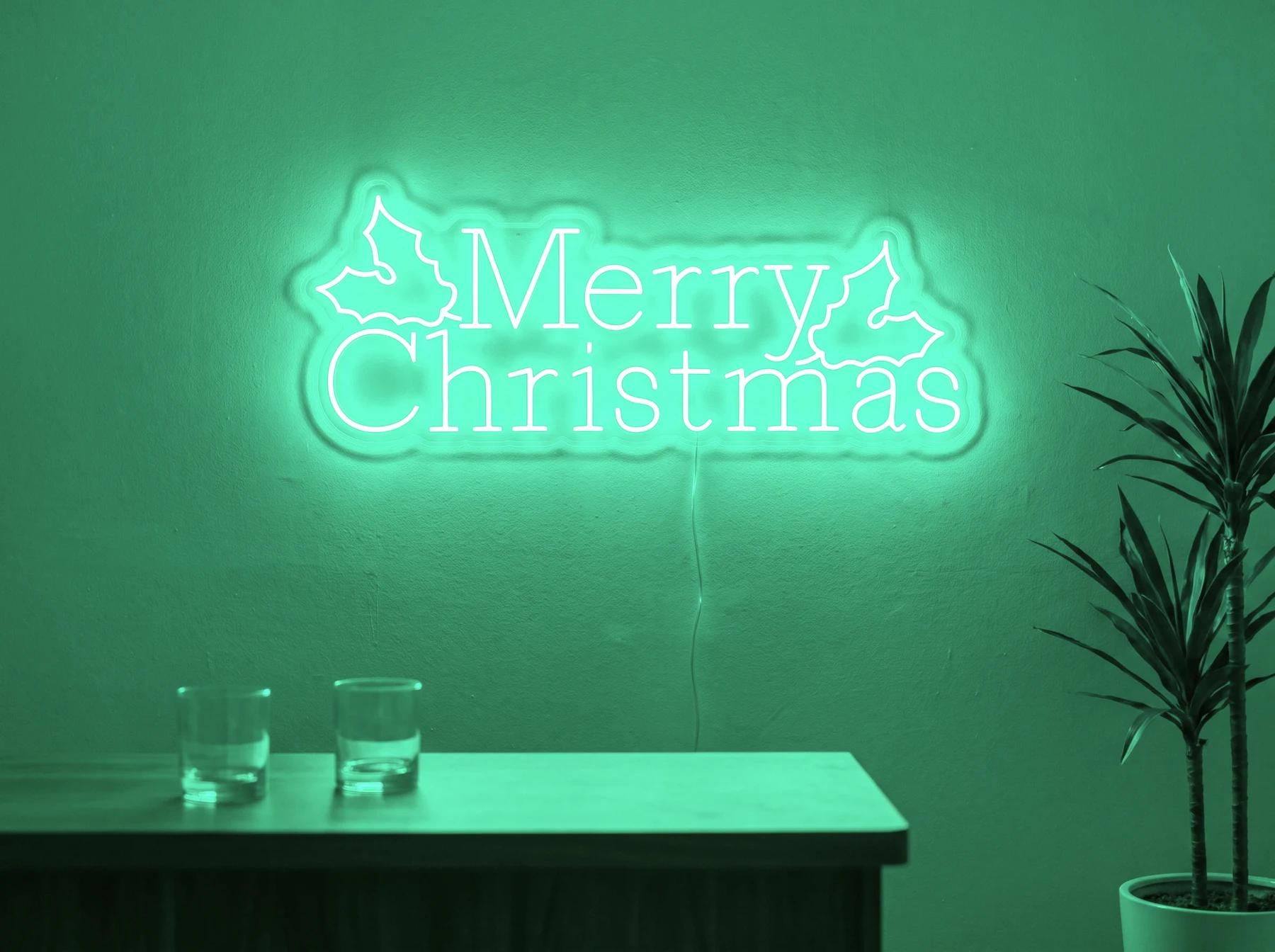 Neonskylt «Merry Christmas» i mintgrön LED-neon, monterad på vägg