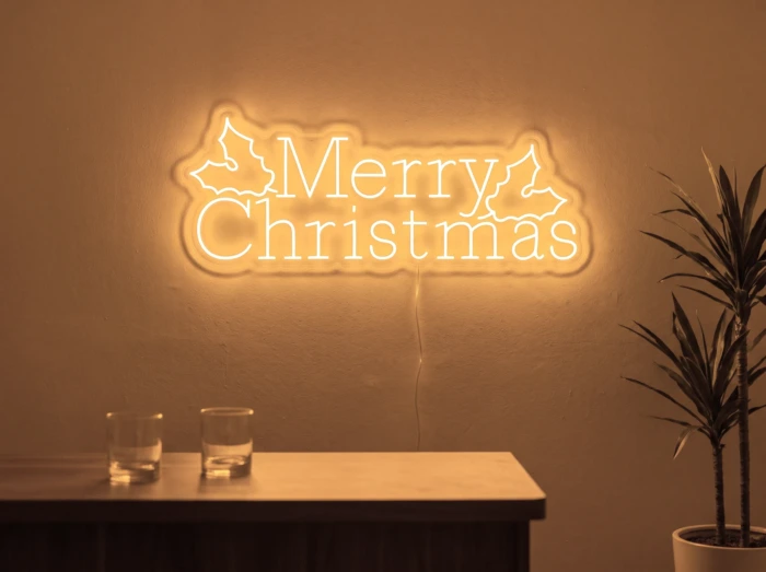 Neonskylt «Merry Christmas» i orange LED-neon, monterad på vägg