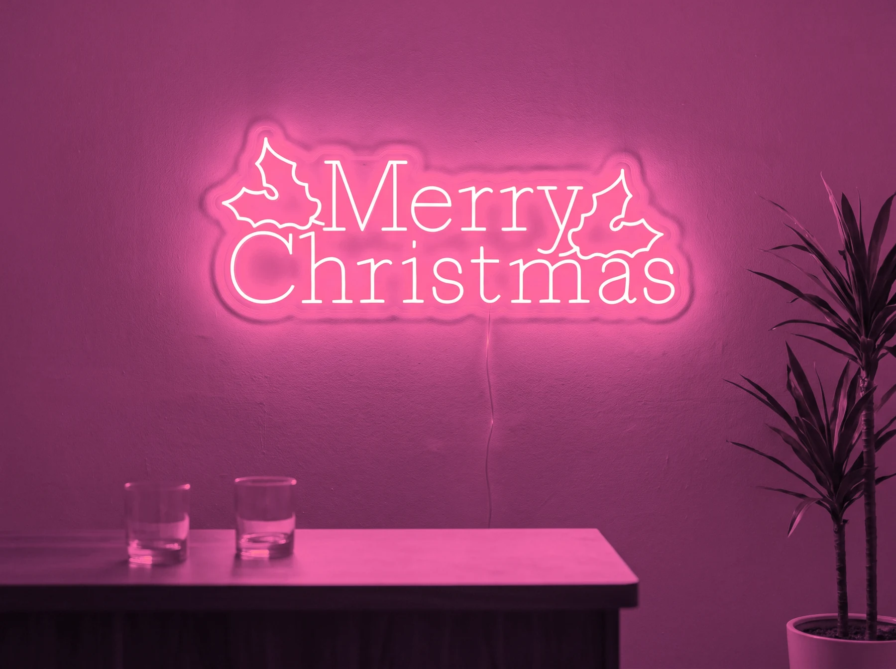 Neonskylt «Merry Christmas» i rosa LED-neon, monterad på vägg