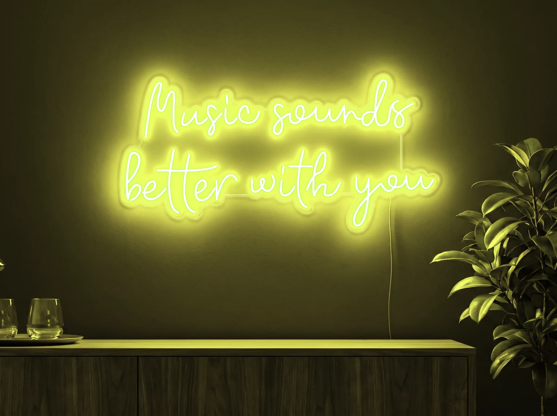 Neonskylt «Music Sounds Better With You» i gul LED-neon, monterad på vägg