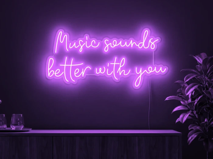 Neonskylt «Music Sounds Better With You» i lila LED-neon, monterad på vägg