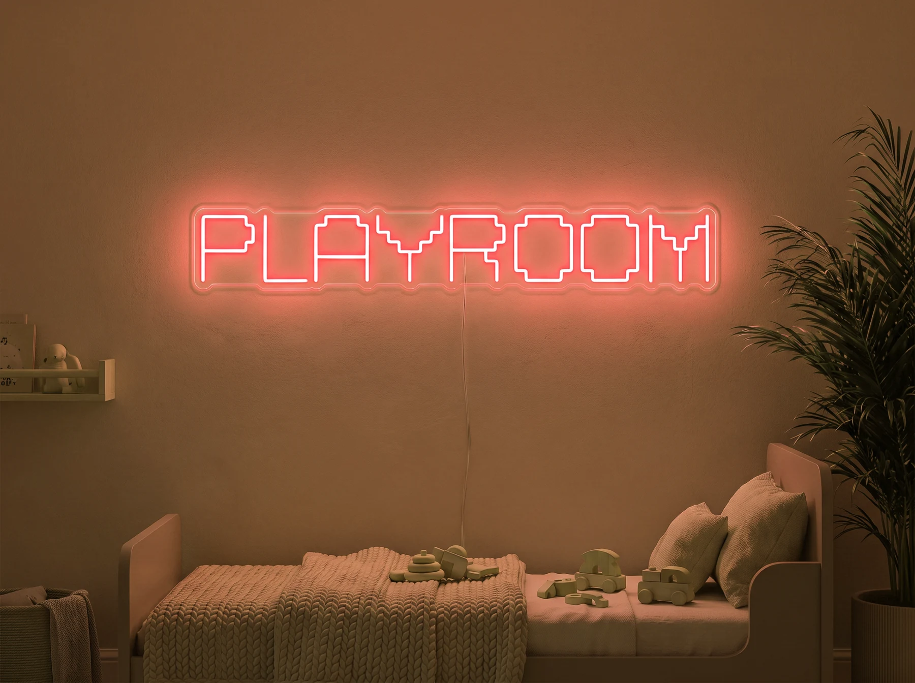 Neonskylt «Playroom» i orange LED-neon, monterad på vägg