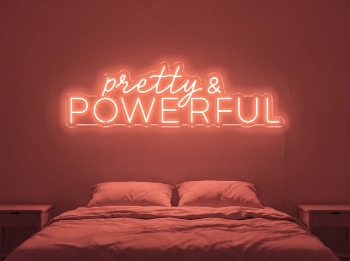 Neonskylt «Pretty And Powerful» i röd LED-neon, monterad på vägg
