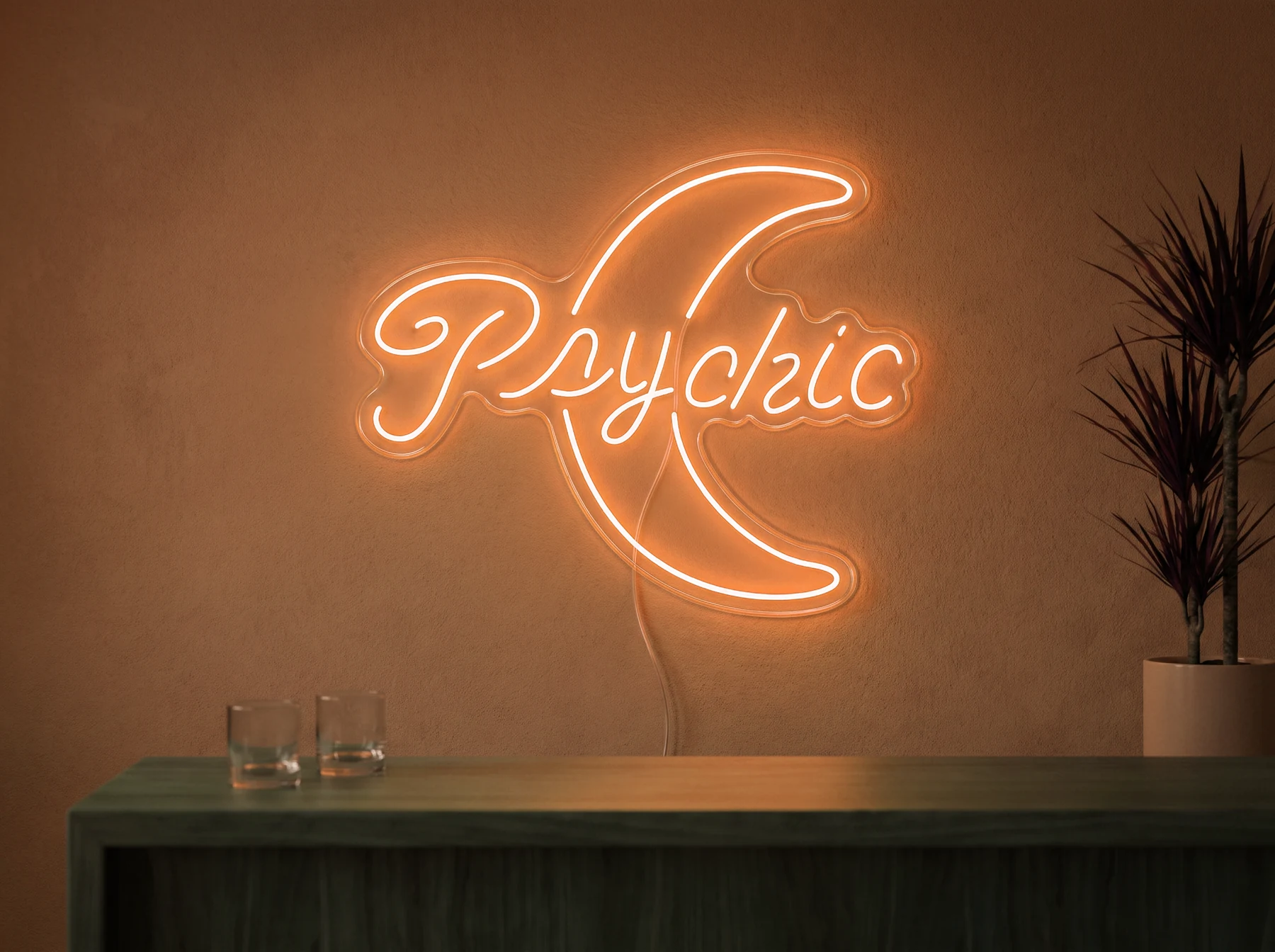 Neonskylt «Psychic» i orange LED-neon, monterad på vägg