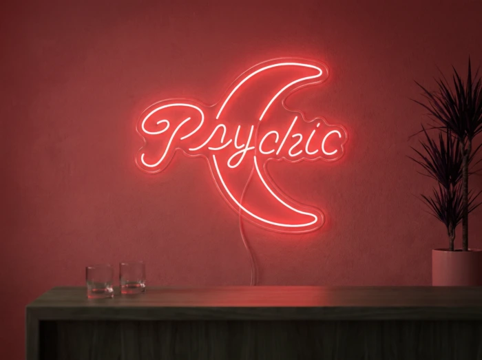 Neonskylt «Psychic» i röd LED-neon, monterad på vägg