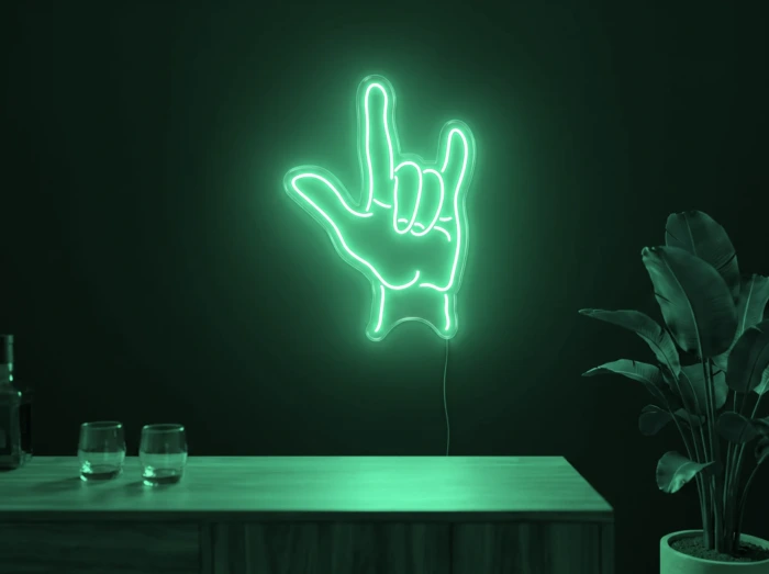 Neonskylt «Rock-hand» i mintgrön LED-neon, monterad på vägg