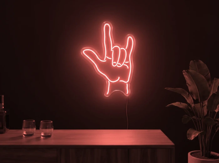 Neonskylt «Rock-hand» i röd LED-neon, monterad på vägg