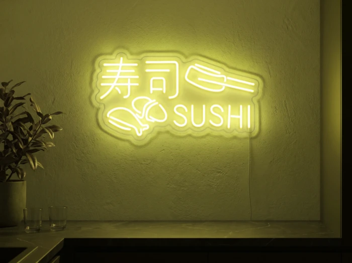 Neonskylt «Sushi» i gul LED-neon, monterad på vägg